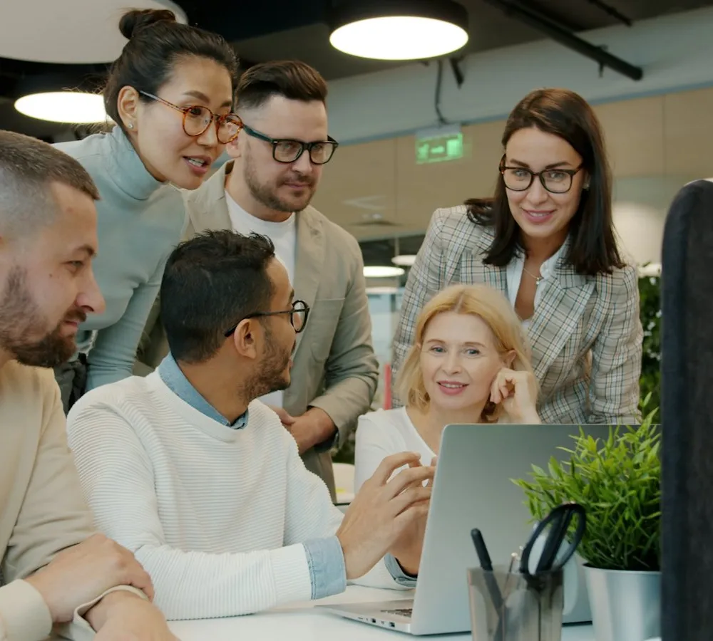 Small team working together around a laptop